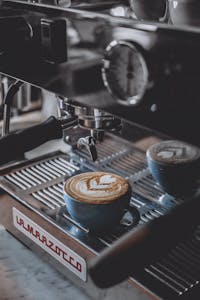 Delicious cappuccino with latte art served on a professional espresso machine in a coffee shop.